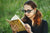 woman reading while wearing sunglasses